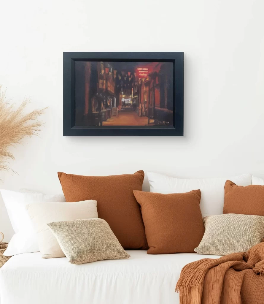 Dublin Dame Lane street at night — warm streetlights and reflections on the pavement, framed in a living  setting, by Deirdre Hayes.