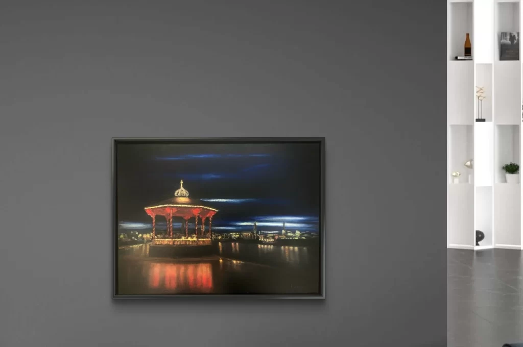 Night-time oil painting of the Dún Laoghaire bandstand with colourful reflections on the water, by Deirdre Hayes.
