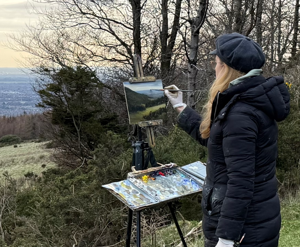 Artist Deirdre Hayes painting outdoors at Ticknock in the Dublin Mountains
