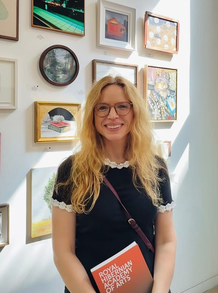 Irish oil painter Deirdre Hayes beside her painting GAA Club at Vsrnishing Day the 196th Royal Hibernian Academy (RHA) Annual Exhibition 2026 in Dublin.